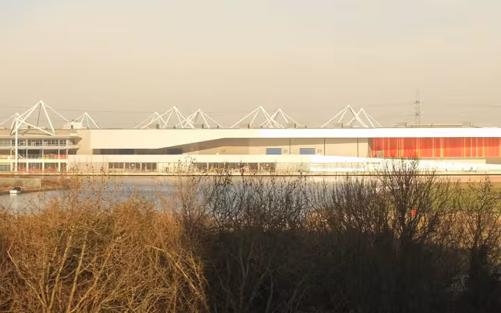 ExCeL Exhibition Centre London, modern building with white roof and waterfront