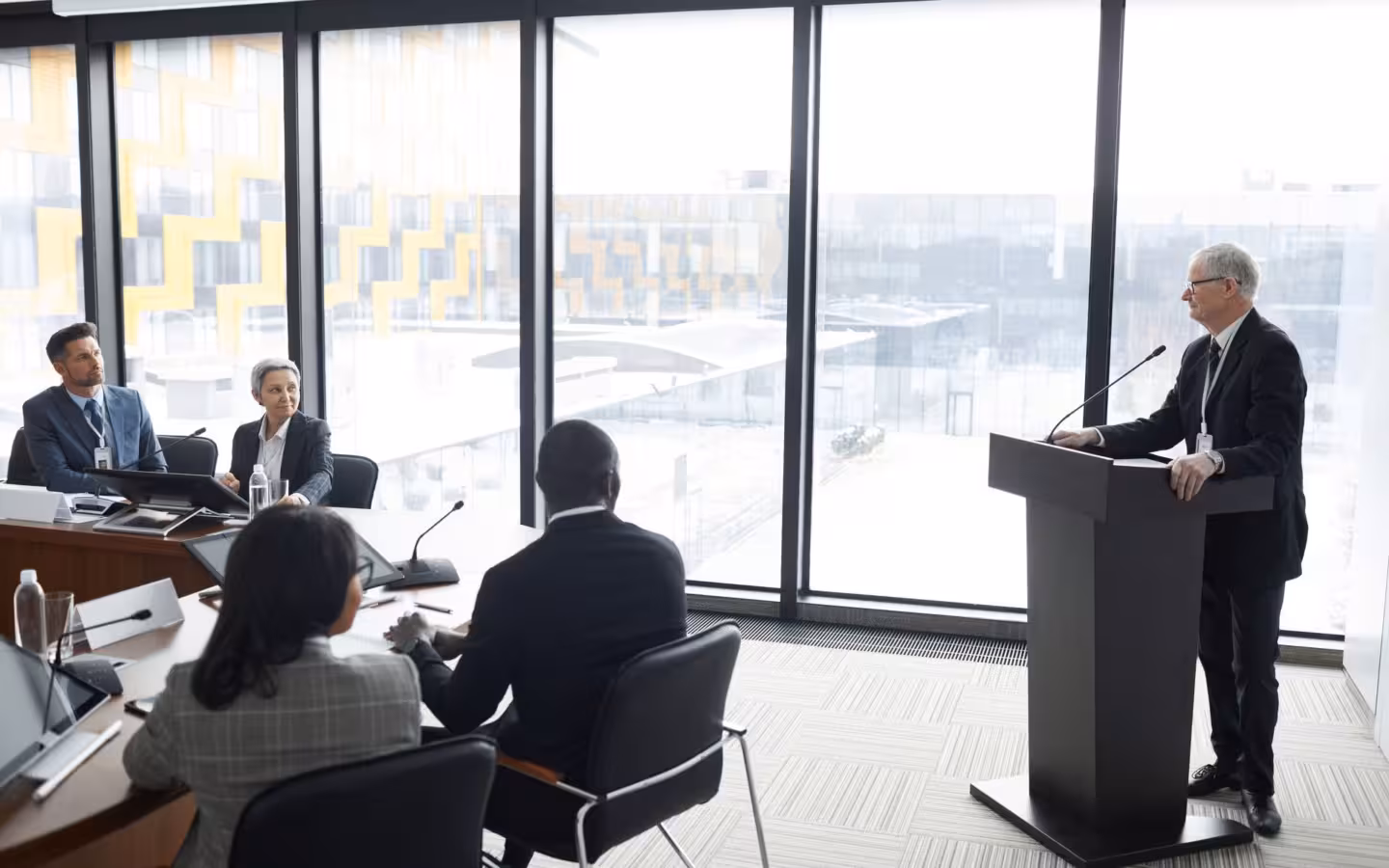 Corporate professionals in a modern conference room attending a business meeting
