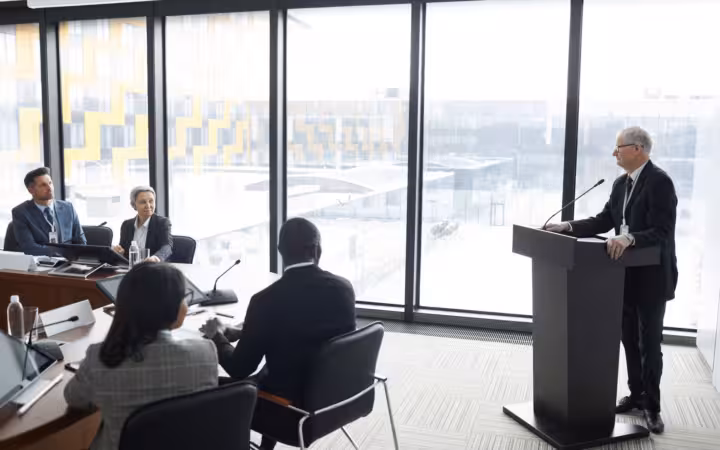 Corporate professionals in a modern conference room attending a business meeting