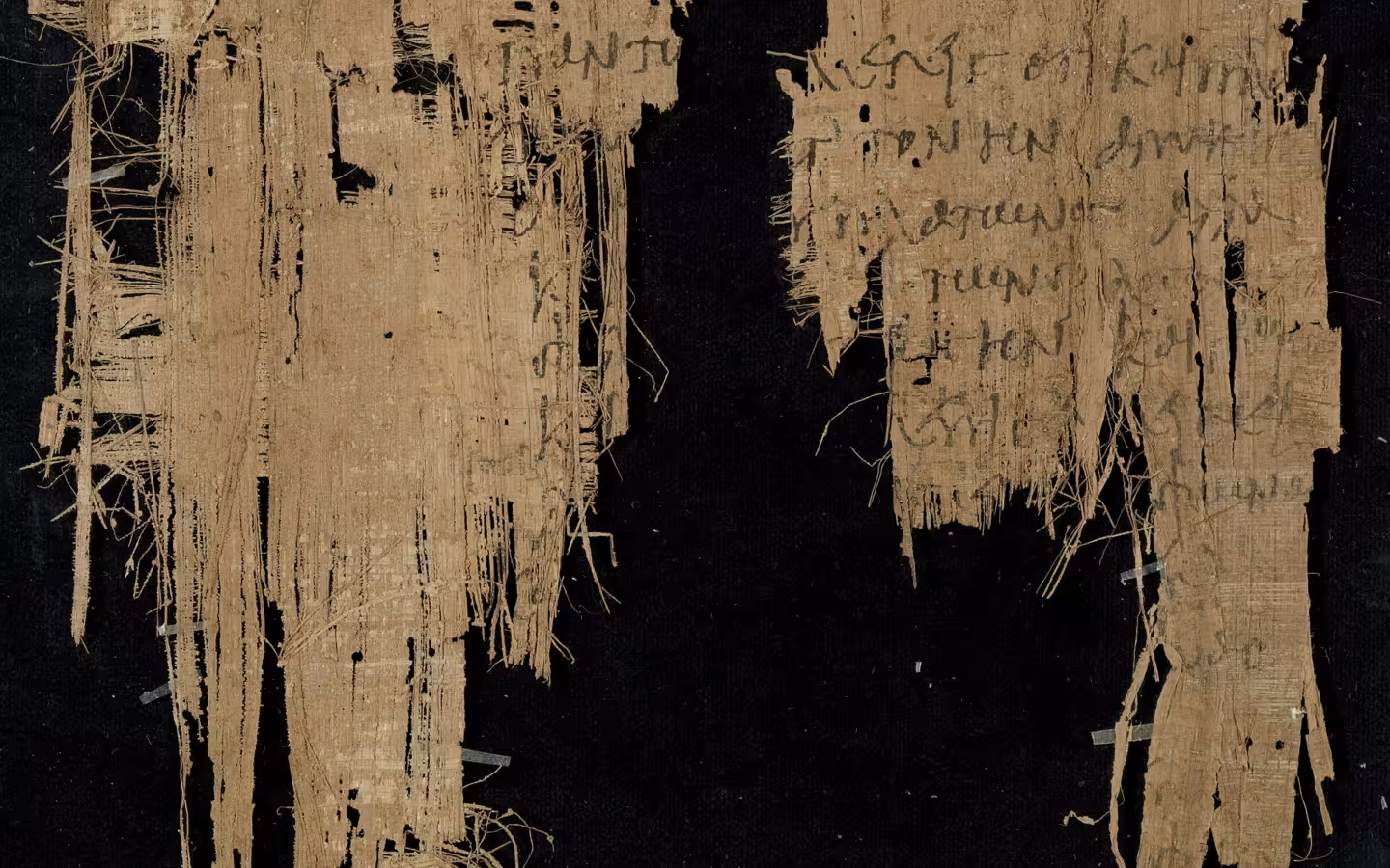 Two ancient Greek papyrus fragments with handwritten text