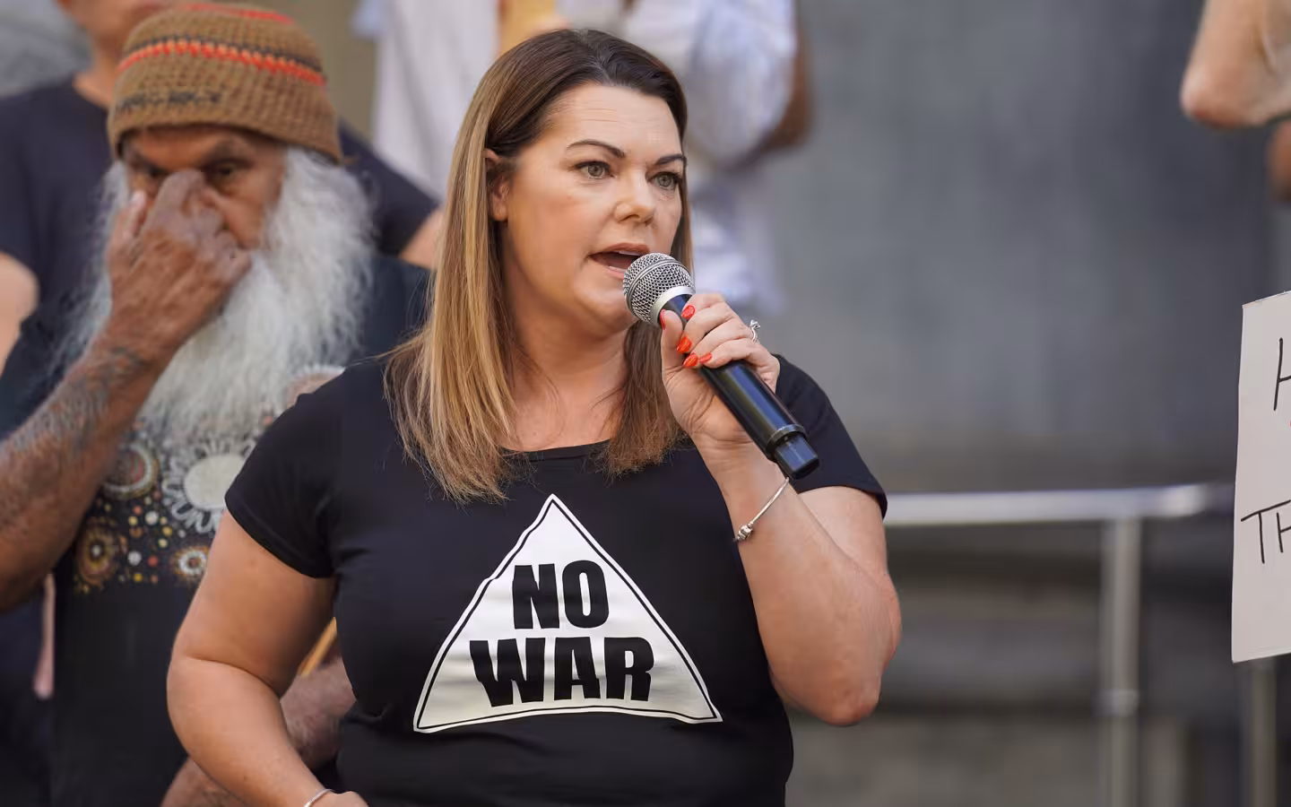 Sarah Hanson-Young speaking into a microphone at an outdoor rally