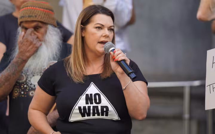 Sarah Hanson-Young speaking into a microphone at an outdoor rally