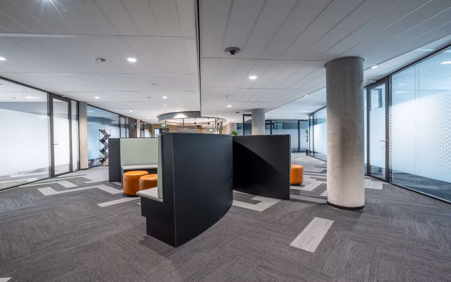 Spacious modern office interior featuring contemporary furniture and open workspace.