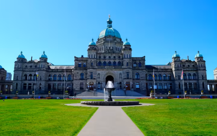 British Columbia Parliament Building exterior under a clear blue sky
