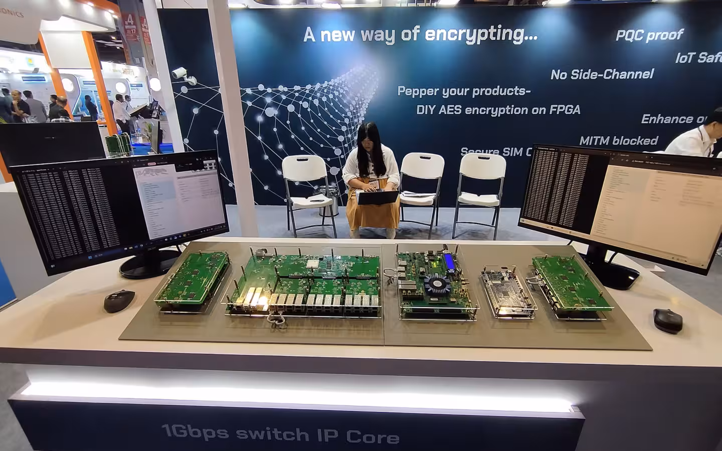 China Telecom stall with circuit boards and monitors at a trade exhibition.