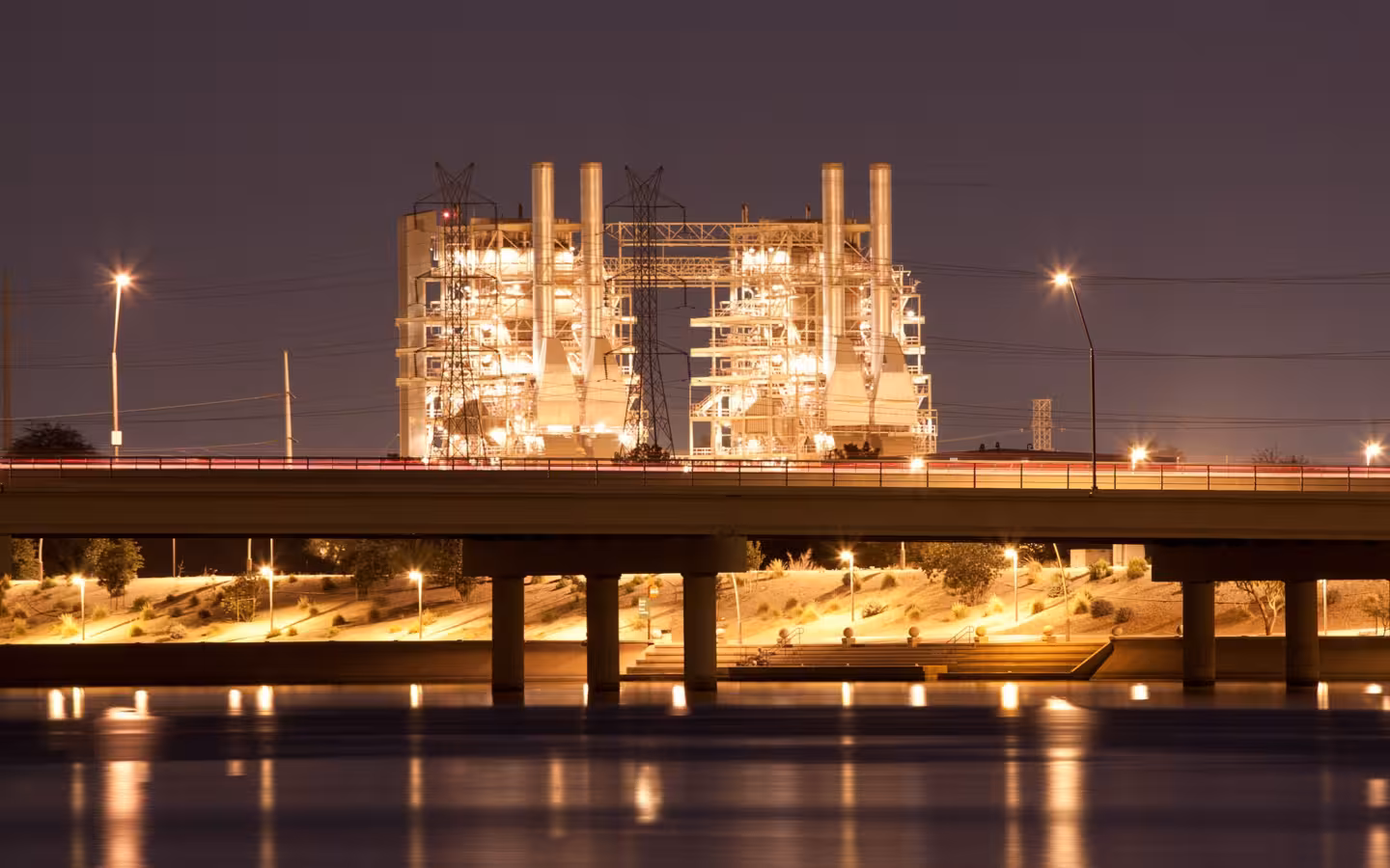Ocotillo Power Plant at night with Tempe Town Lake in the foreground.