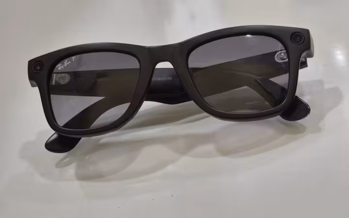 Black Ray-Ban Meta glasses with Polaroid lenses on white surface