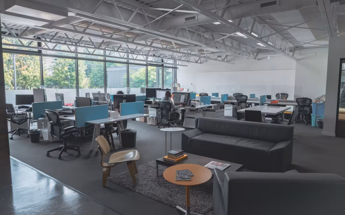 spacious modern office with desks, computers, natural light