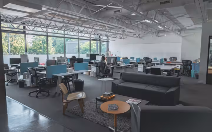 spacious modern office with desks, computers, natural light