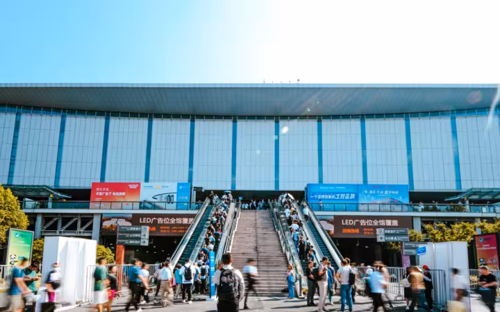 People entering Shanghai exhibition center via outdoor escalator daytime