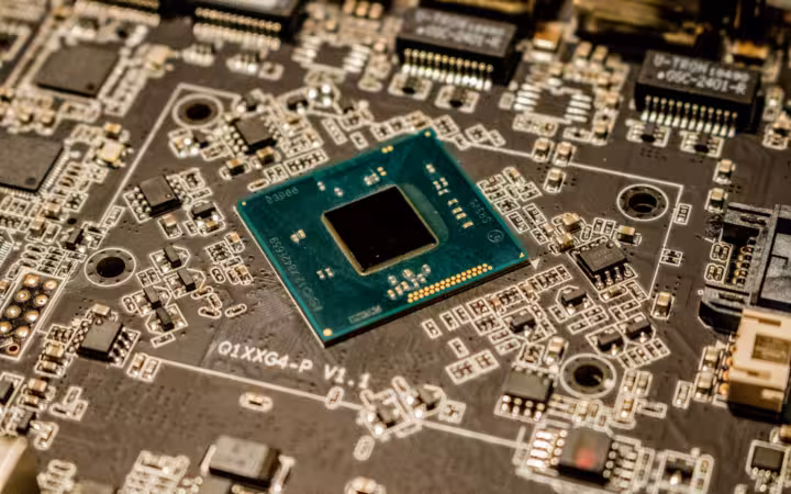 Detailed view of a microchip on a printed circuit board showcasing electronic components