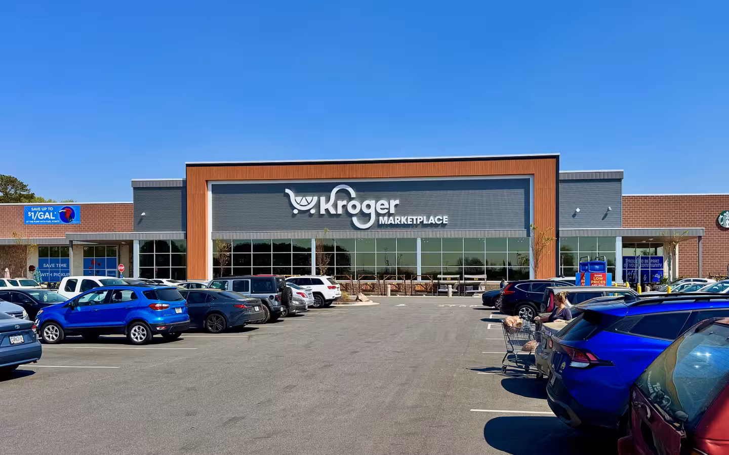 The exterior of a Kroger Marketplace store in Athens, Georgia, with a parking lot.