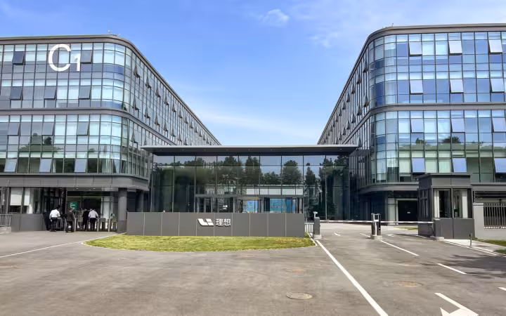 The modern glass facade of the Li Auto R&D Headquarters, Block C