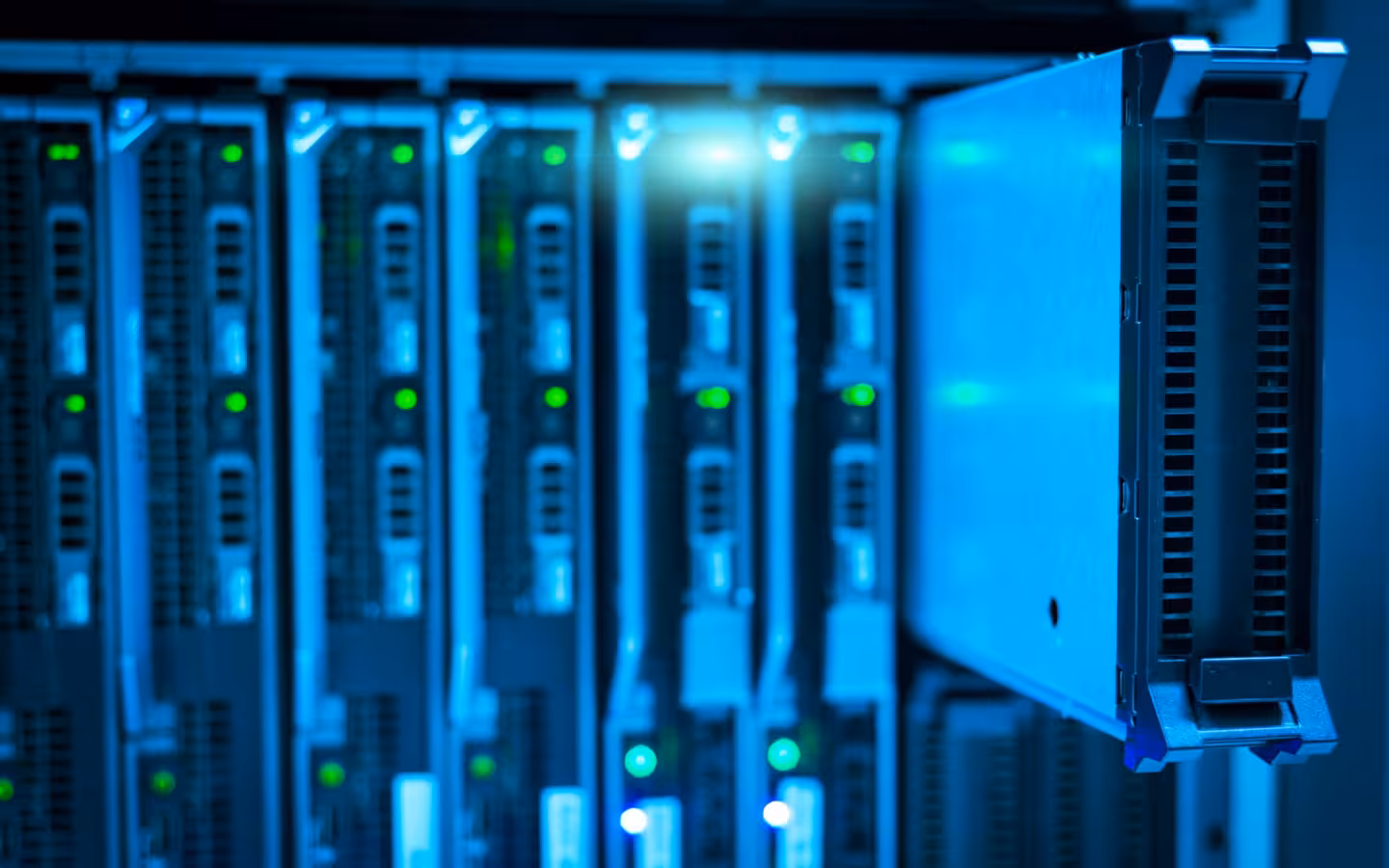 Detailed view of a server rack with illuminated green indicator lights