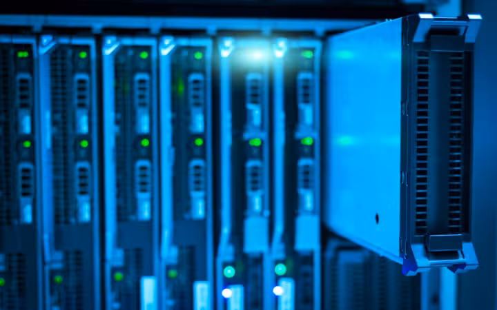 Detailed view of a server rack with illuminated green indicator lights