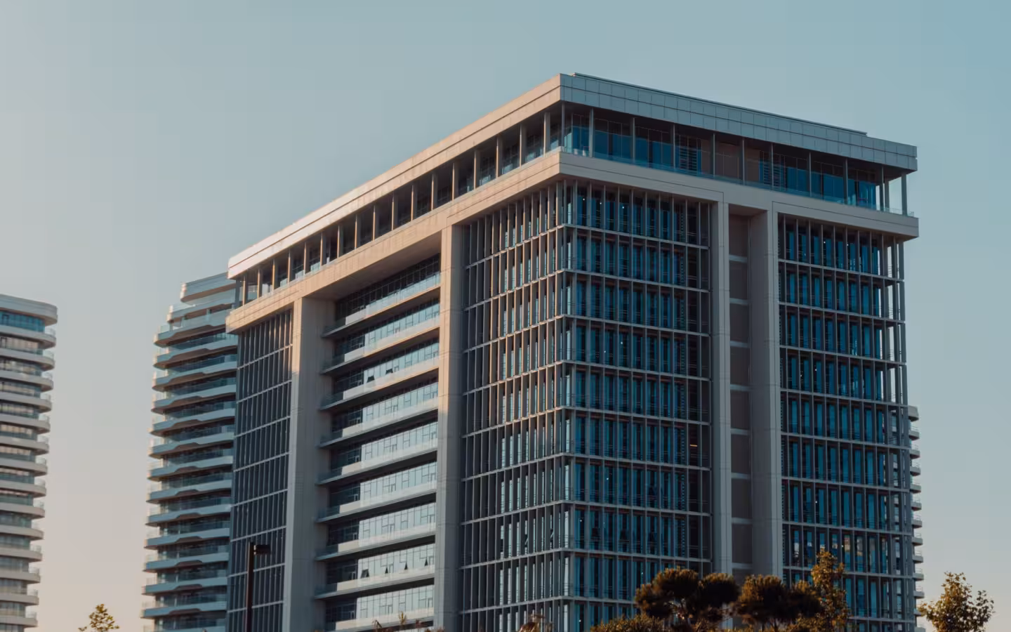 modern highrise building with glass facade against clear sky