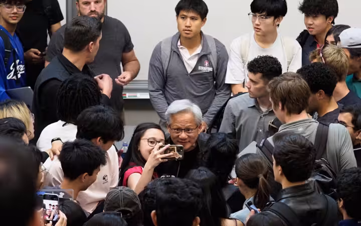 Jensen Huang poses for selfies with students at Stanford