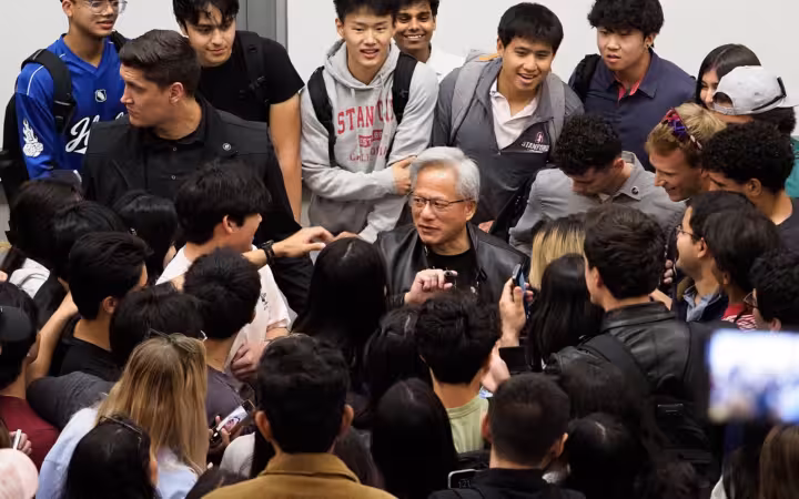 Jensen Huang, CEO of Nvidia, surrounded by students after his talk at Stanford University on April 30, 2026