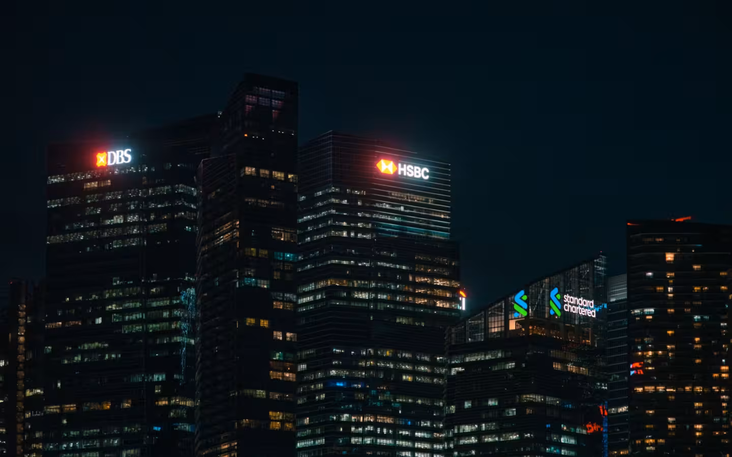 Illuminated skyscrapers of major banks in Singapore financial district at night