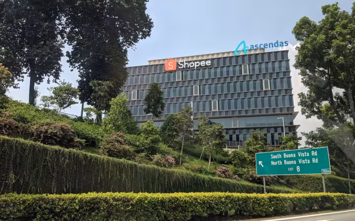 Shopee headquarters building with signage on a landscaped hillside