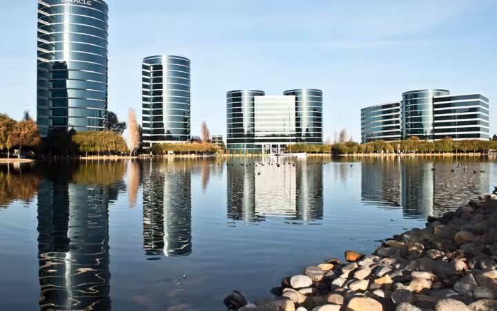 Oracle headquarters building complex reflected in calm water