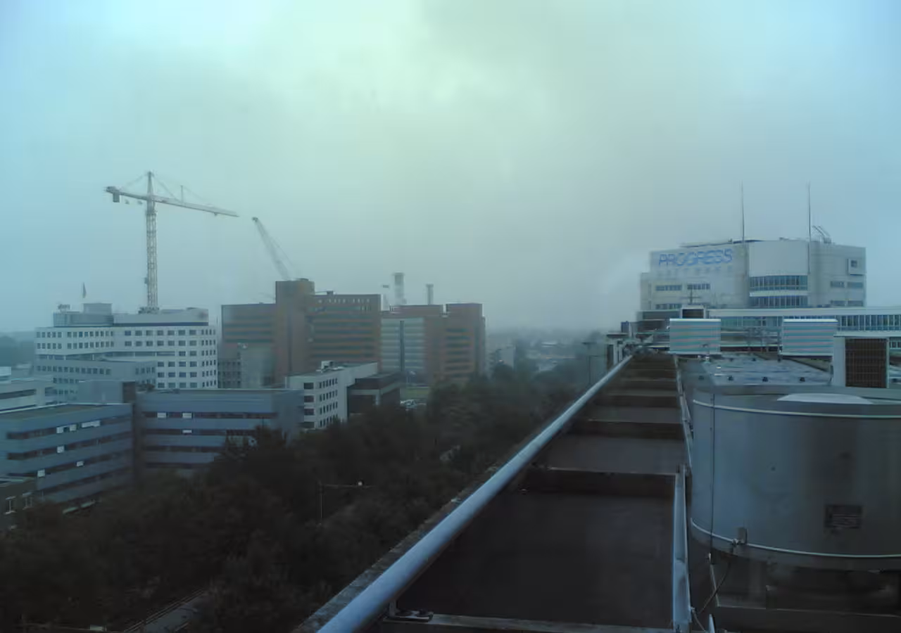 An elevated view of the office of Progress Software in Rotterdam under an overcast sky.