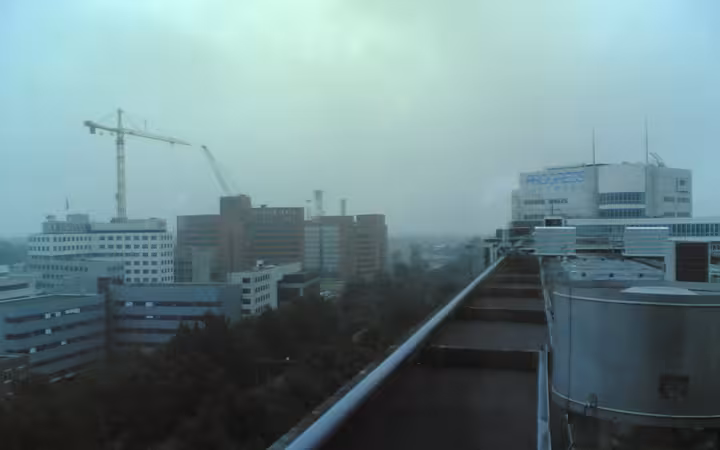 An elevated view of the office of Progress Software in Rotterdam under an overcast sky.