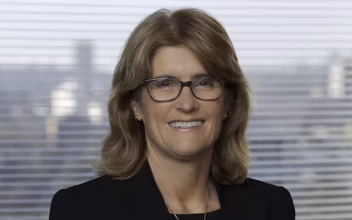Portrait of Australian economist Michele Bullock smiling wide