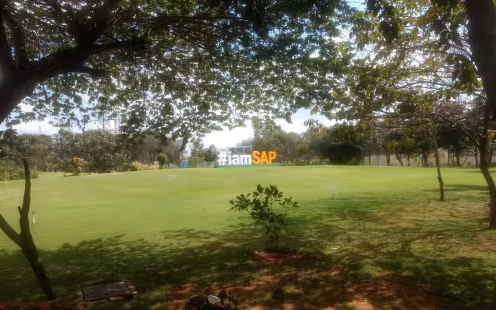SAP Labs India campus sign on a grassy field