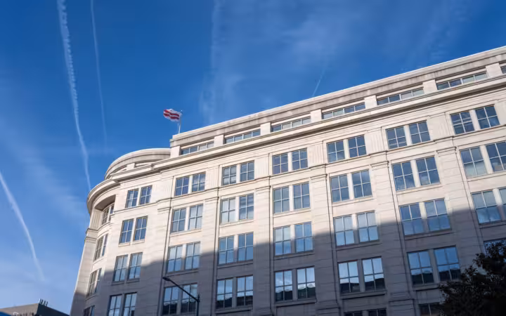 Elegant office building under clear blue sky in Washington D.C.