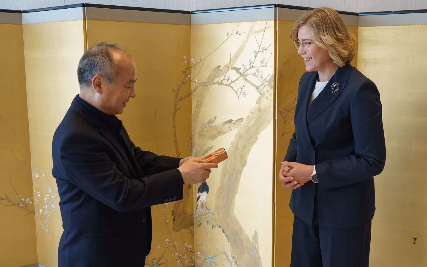 Masayoshi Son exchanges gift with smiling Henna Virkkunen