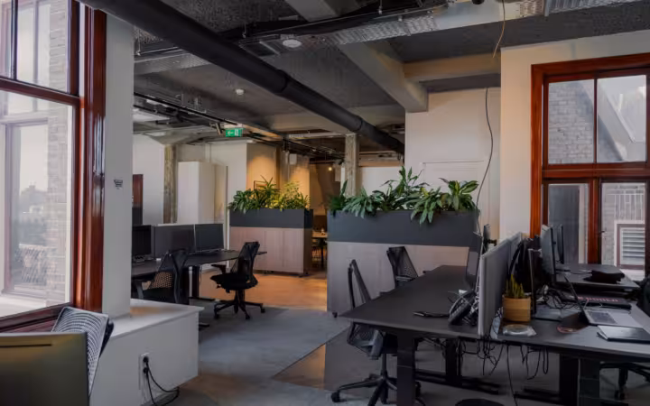 Contemporary office space with desks and plants