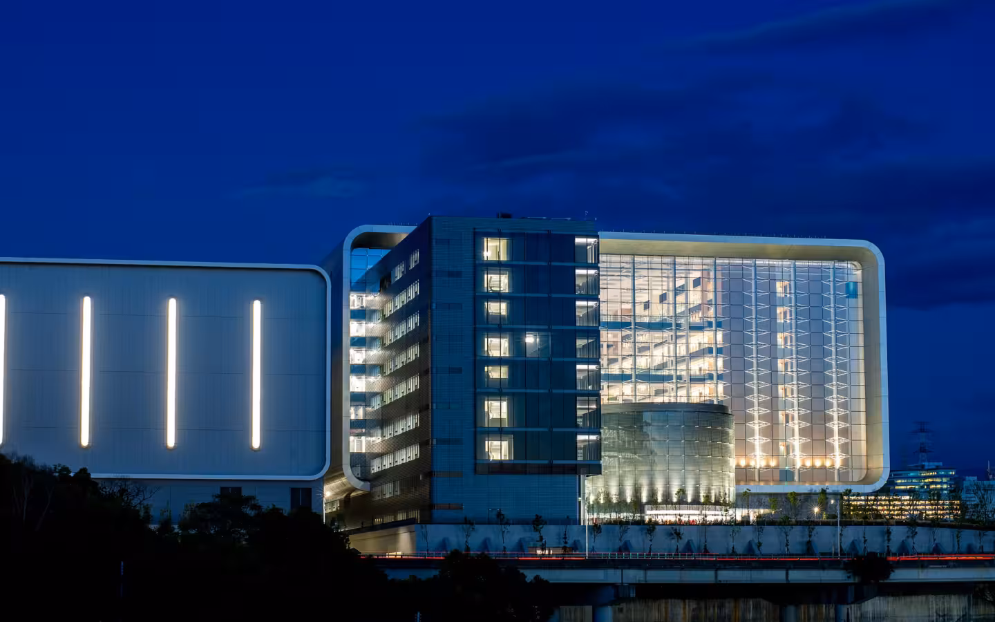Illuminated TSMC Global R&D Center building at night against a dark blue sky.
