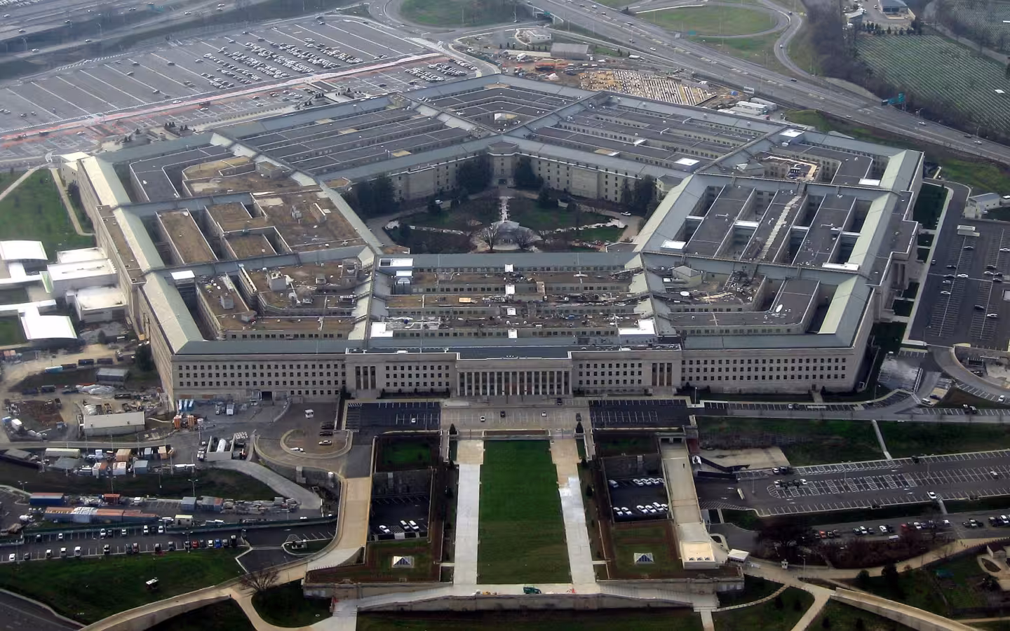 An aerial view of the Pentagon building with surrounding parking lots and highways.