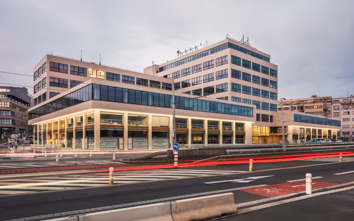 a wide exterior view of a large modern multi-story office building
