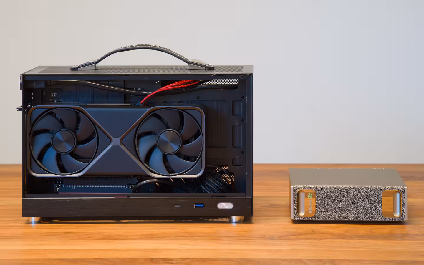 A compact PC with NVIDIA GeForce RTX 5070 beside NVIDIA DGX Spark.