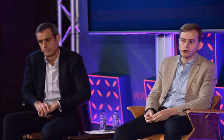 Robert Wainwright and Adam Hadley seated on the Web Summit Forum Stage.