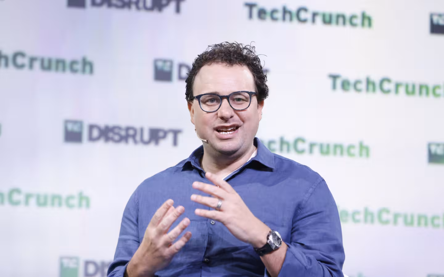 Anthropic CEO Dario Amodei speaking onstage before a TechCrunch Disrupt backdrop