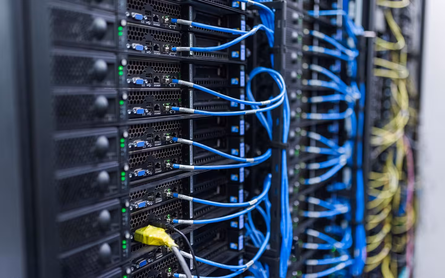 Server racks and blue cables at the FZU Computing Centre in Prague.