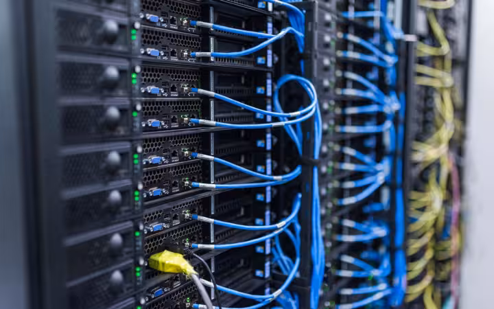 Server racks and blue cables at the FZU Computing Centre in Prague.