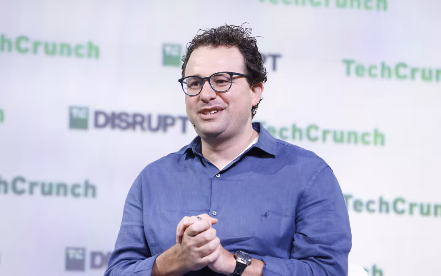 Dario Amodei speaking onstage before a TechCrunch Disrupt backdrop.
