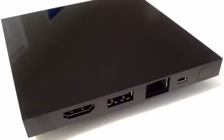 A black Android TV set-top box with HDMI, USB and Ethernet ports