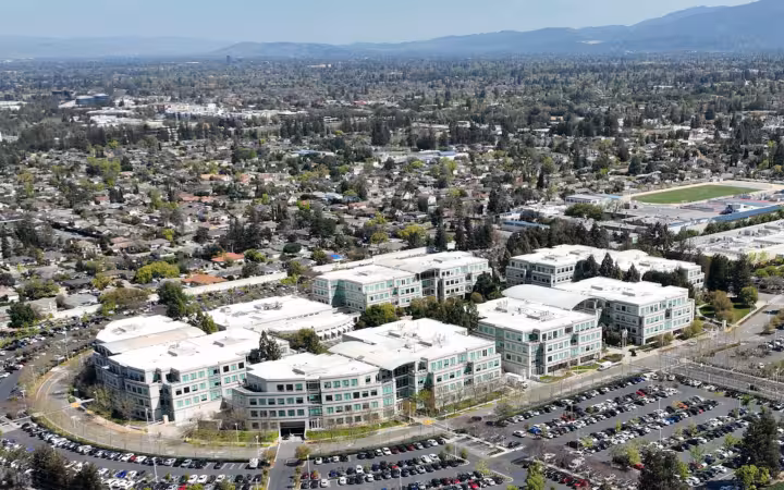 Aerial view of Apple's former Infinite Loop campus amid Cupertino neighborhoods.