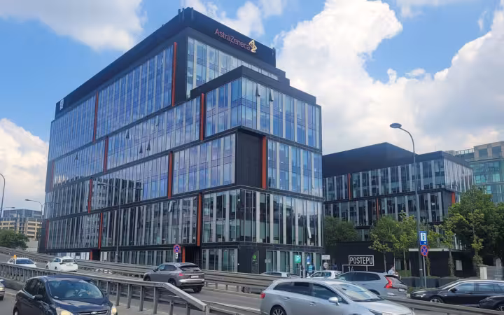 AstraZeneca building at 14 Postępu Street in Warsaw above passing traffic