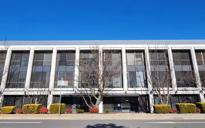 Reserve Bank of Australia building across a street beneath a blue sky