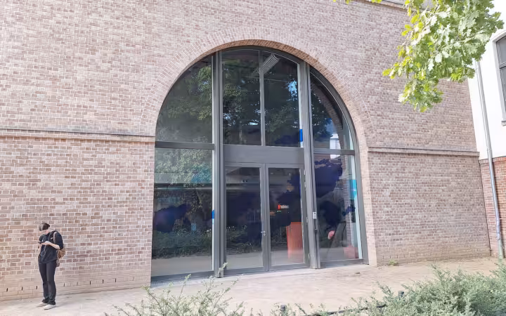 Alphabet's recorded Berlin headquarters, a brick facade with an arched glass entrance