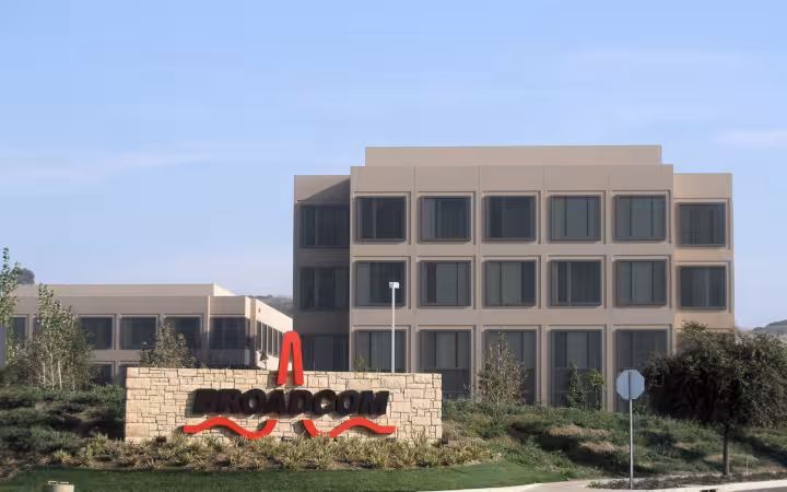 Broadcom headquarters behind a prominent company sign and landscaped grounds