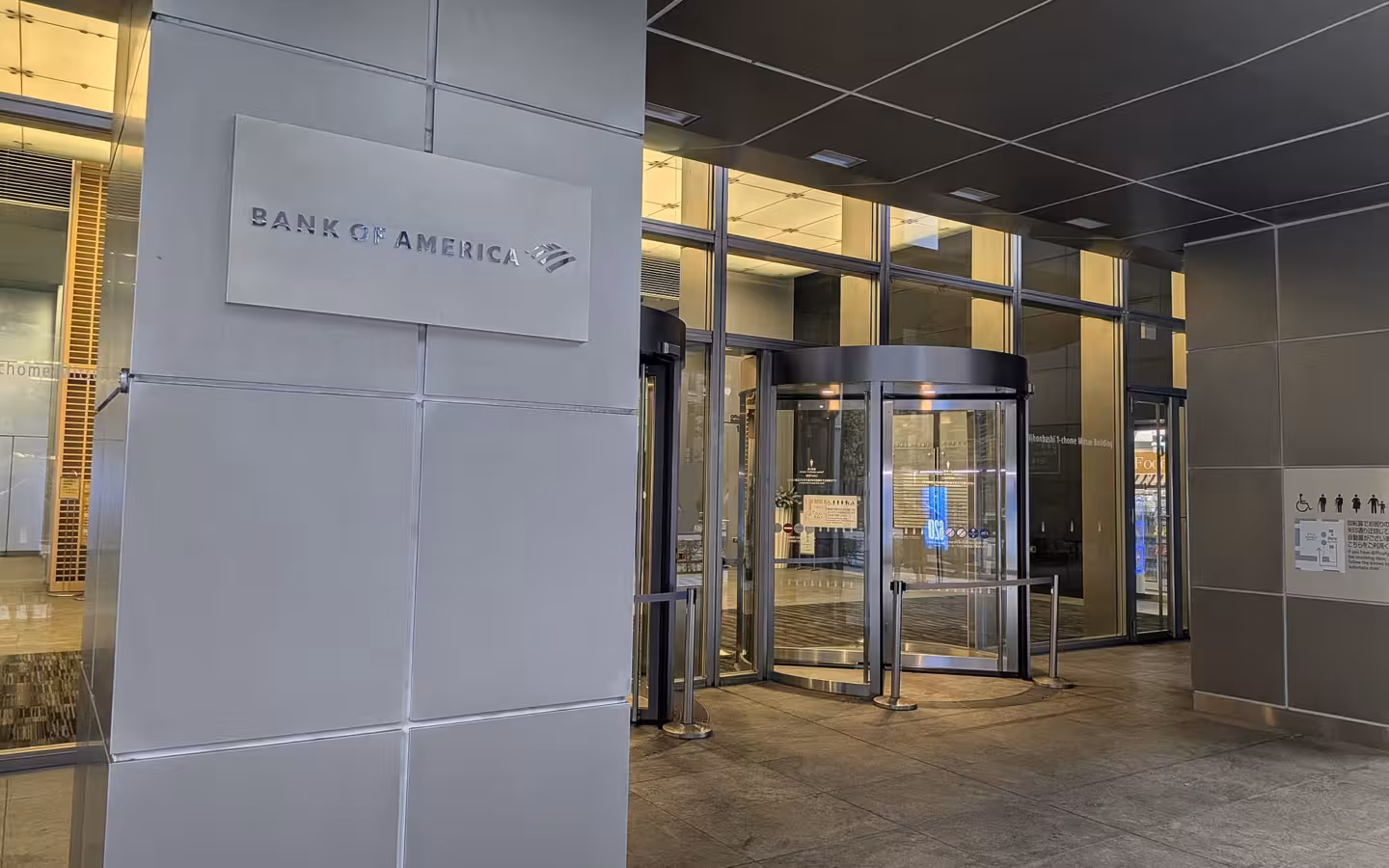 Bank of America sign beside a glass building entrance in Nihonbashi