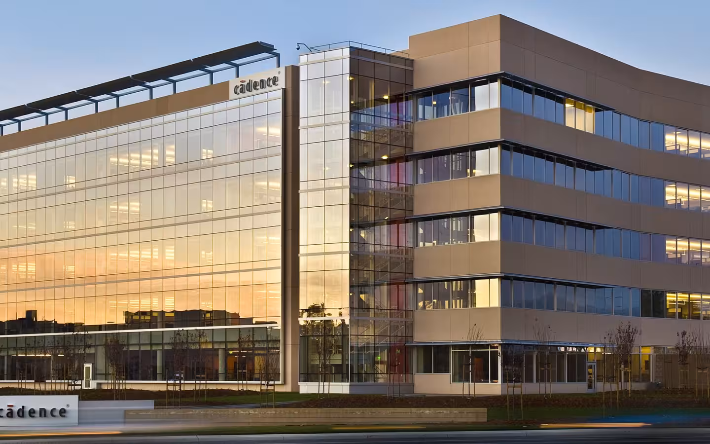 Cadence Design Systems headquarters, a glass-fronted office building at sunset