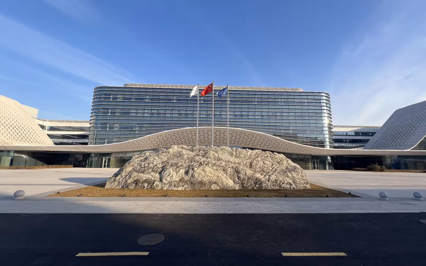 CSCN headquarters in Xiong'an behind a rocky plaza and three flagpoles